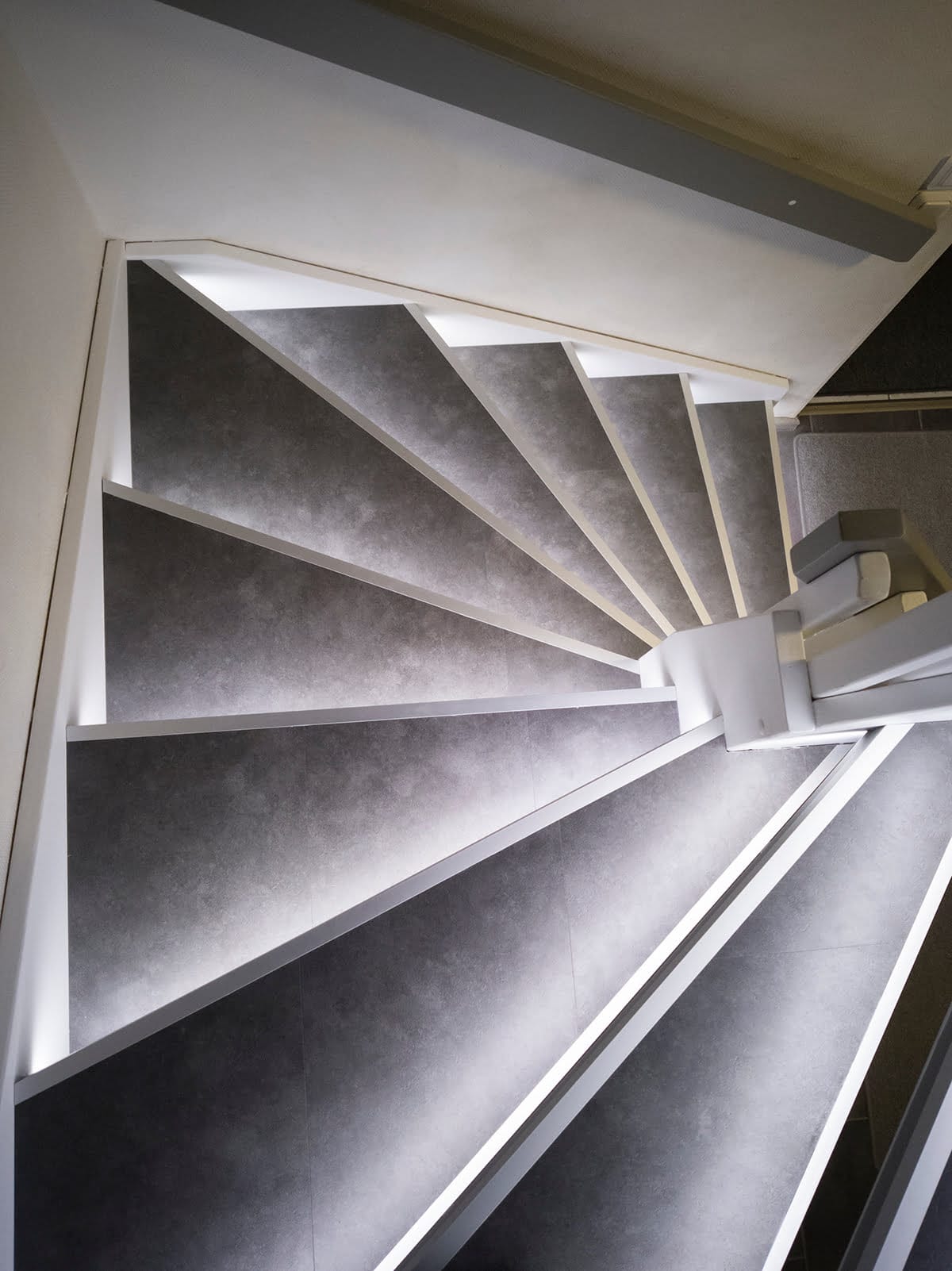 Stairs pictured from above, with the step lights on.