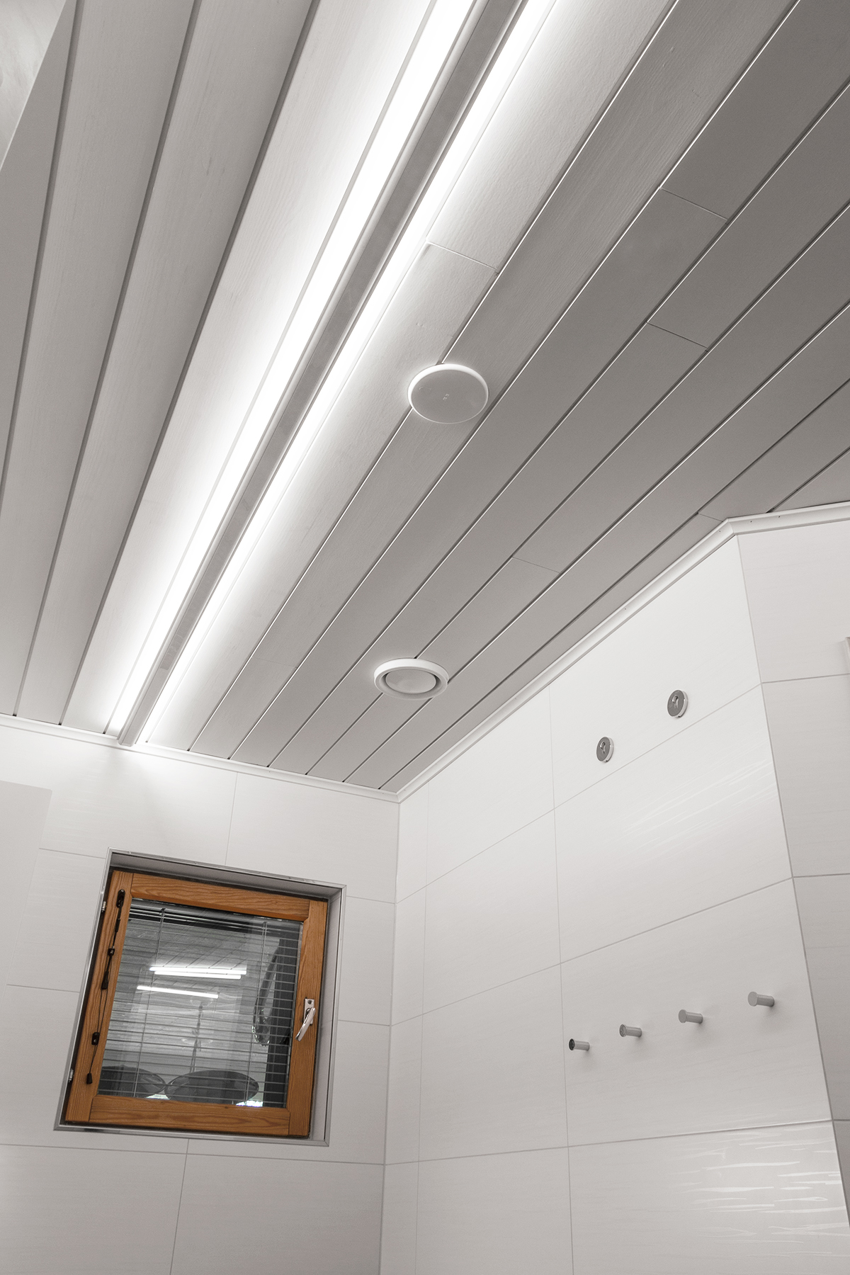 led profiles in the ceiling giving indirect light to the bathroom
