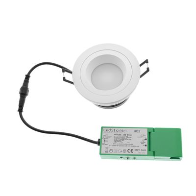 Round LED downlight with metal clips, connected to a green power supply with a black cable. Ideal for energy efficient indoor lighting.