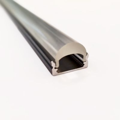 Close-up of an aluminium LED profile with a rounded diffuser on a white background, elegant design and modern lighting solution.