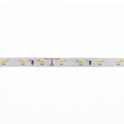 Close-up of an LED strip light featuring yellow diodes and resistors on a white background; an energy efficient lighting solution.