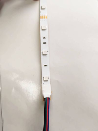 LED strip light with four coloured wires: red, green, blue, black for versatile connection - an ideal energy-efficient lighting solution.