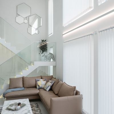 Modern living room with LED lighting, beige sofa, decorative ivory statues, geometric mirrors, marble coffee table and white vertical curtains.