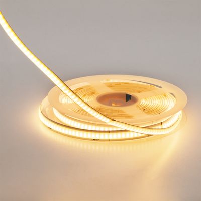A twisted ribbon of warm white LED lights, partially open, glowing beautifully against a neutral background - ideal for energy efficient lighting solutions.
