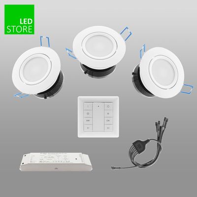 Three white LED downlights, remote control, wires, power supply in grey. Green 'LED Store' logo in upper left corner. Improve your lighting solutions with our products.