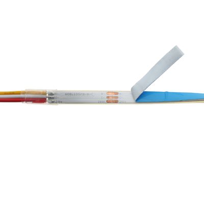LED strip light detail showing diodes, wires and partially removed adhesive for lighting installation.