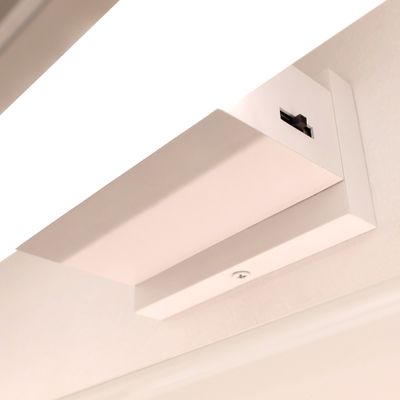 Close up of a wall mounted led game light. A switch can be seen on the cover of the lamp.