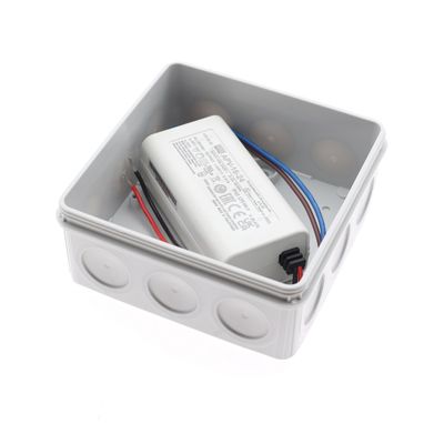 Square electrical junction box with white power supply and black, red and blue wires for LED lighting solutions.