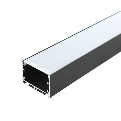Rectangular black LED luminaire with white glow, oblique view on plain white background, ideal modern lighting solution.