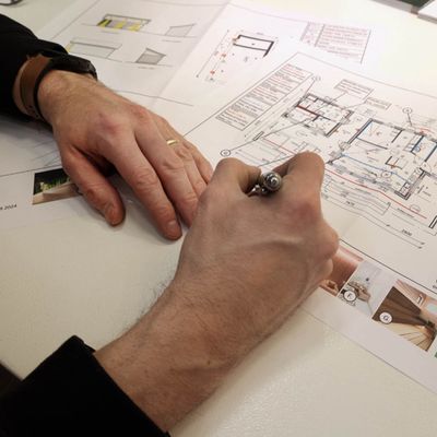 Lighting design analysis of architectural floor plans in pencil, on a desktop, in an interior lighting context.