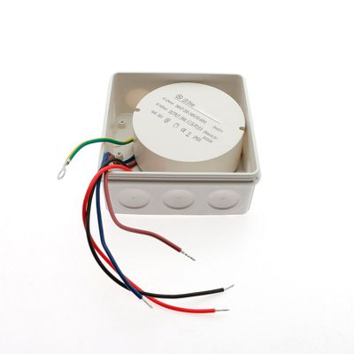 Square electrical junction box with round device and five wires: green/yellow, red, black, blue, brown for connecting LED lighting.
