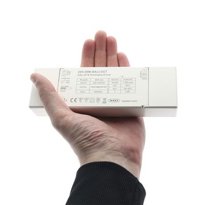 Close-up of a hand-held rectangular white LED controller with clear printed labels and specifications for efficient lighting solutions.