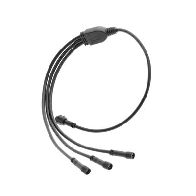 "Black three-way distribution cable with central connector and three branches, designed for LED lighting, insulated with white base.