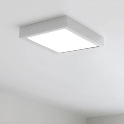 A square ceiling light with bright white light in a minimalist white painted room. Modern LED lighting accentuates any space.