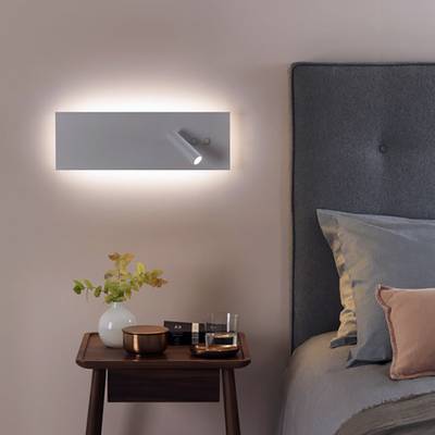 A minimalist rectangular wall lamp that glows softly on a plain white background, a stylish LED luminaire for modern interiors and efficient lighting.