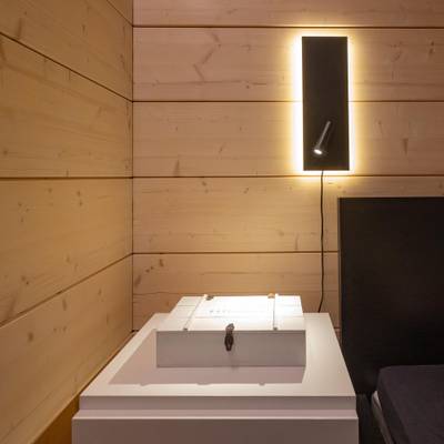 Modern rectangular black wall light with adjustable spotlight, ideal for contemporary interiors and energy efficient LED lighting solutions.