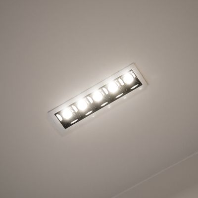 Rectangular recessed ceiling light with five LED bulbs brilliantly illuminates a modern room, enhancing ambience and energy efficiency.