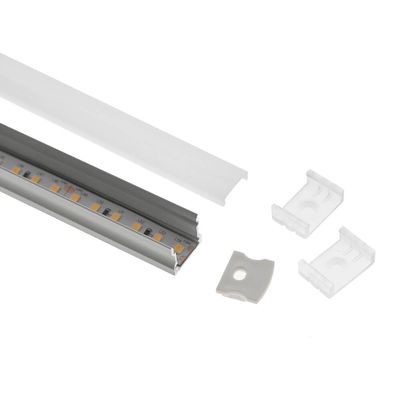 LED strip luminaire with aluminium housing, diffuser cover and two mounting clips on white base for energy efficient lighting solutions.