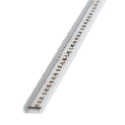 Close-up of a slim white LED strip light, showcasing multiple LEDs in a linear arrangement, perfect for modern lighting solutions.