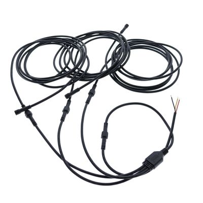 LED lighting installation cables with connectors and bare wires, coiled on a white background.