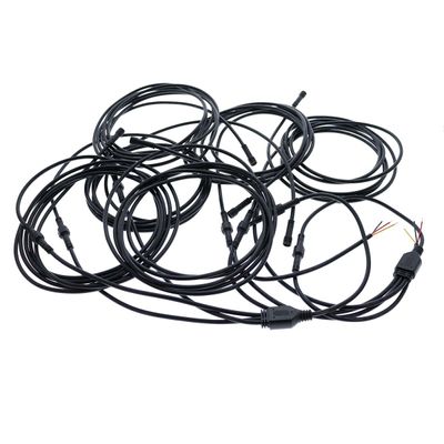 Black LED fibre optic cables with connectors and visible wires, wrapped and tangled on a white background.