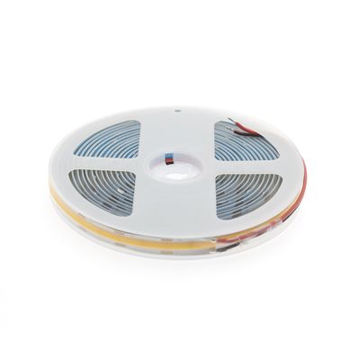 Twisted LED strip light with white coil with blue circuit lines and edge connectors, ideal for efficient and customizable lighting solutions.