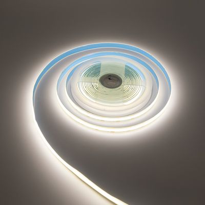Warm glowing spiral LED strip light spiral on a flat surface, an energy efficient lighting solution for home and commercial spaces.