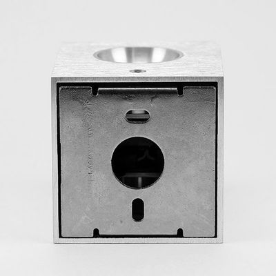 Modern metallic cube-shaped LED luminaire with a circular front opening against a clean background. Perfect for stylish lighting solutions.