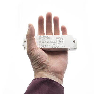 Close-up of a hand holding a rectangular LED lighting product with technical specifications visible. Showing technical details for energy efficient lighting.