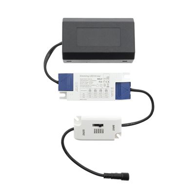 Alternative text: "LED lighting components: black box, white and blue LED driver and small white switch with wires for efficient electrical connection.