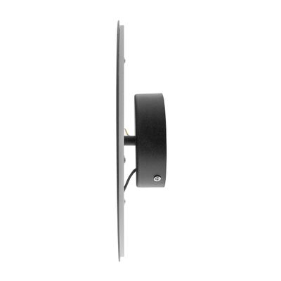 Side view of a modern black wall mounted LED luminaire with a round base and a stylish cylindrical housing. Energy efficient lighting for stylish interiors.