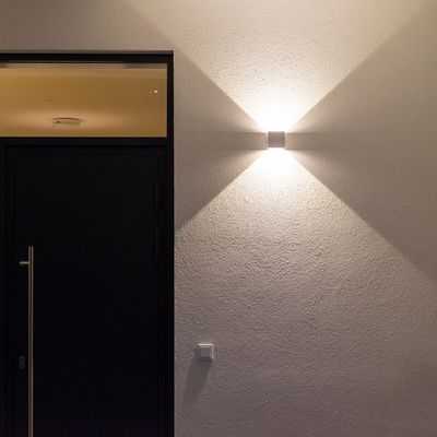 FUNK wall lamp illuminated on the wall.
