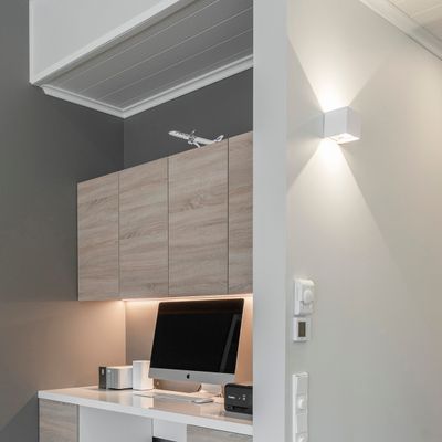 FUNK wall lamp illuminated on the wall.