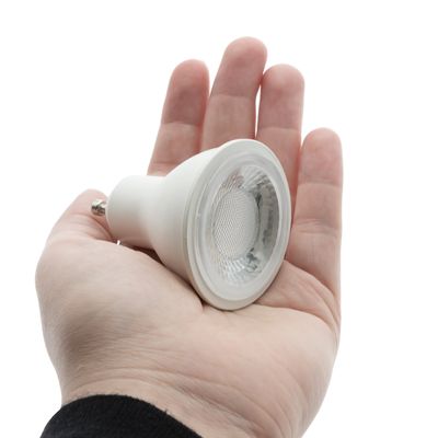 Hand held small round LED lamp with white background highlighting energy efficient lighting solutions from our LED shop.