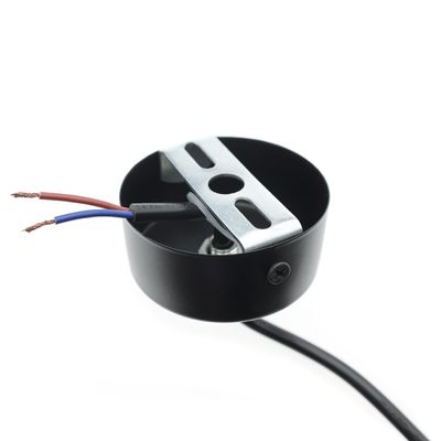 Close-up of a black ceiling light fixture with blue and brown wires on a white background. Mounting accessories for LED lighting.