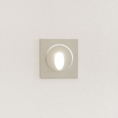 Square recessed wall light with oval LED source on white wall - a modern lighting solution.