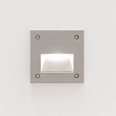 Recessed square wall light illuminates a white textured wall with a soft glow for a modern LED lighting aesthetic.
