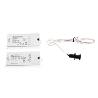 Close-up of two white LED control modules and a black push-button switch with wiring on a white background for enhanced lighting solutions.
