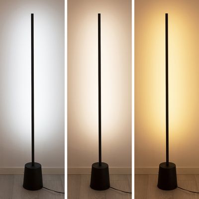 A tall black floor lamp offers soft white, bright white and warm yellow against a neutral wall and highlights versatile LED lighting.