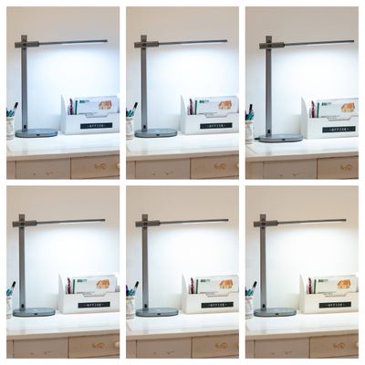 Six workstations with contemporary LED desk lamps in a 2x3 grid, highlighting a modern lighting design.