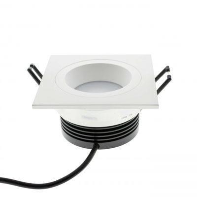 Square recessed LED luminaire with round centre light, black heat sinks and black power cord - a modern and energy efficient lighting solution.