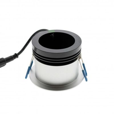 Recessed LED downlight with black interior, metallic exterior and attached power cord for modern lighting solutions.