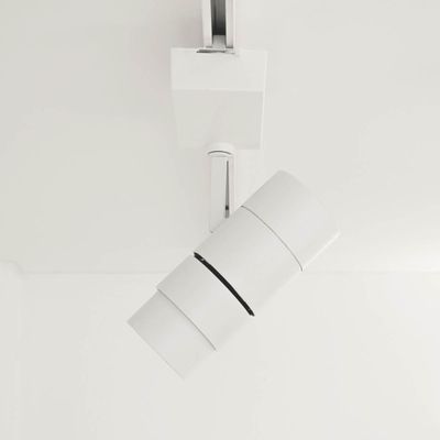 Modern cylindrical white ceiling light with clean lines, installed on a white ceiling by a LED lighting company.