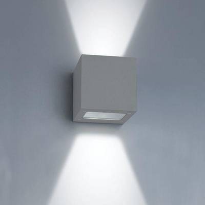 A minimalist wall light illuminates up and down a plain grey wall and accentuates modern LED lighting in your interior.