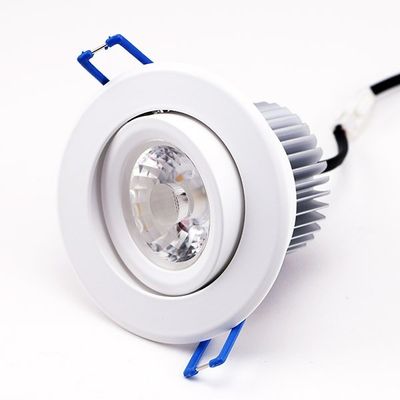 Recessed LED downlight with white frame, visible lens, blue brackets and black connector; energy efficient lighting for modern spaces.