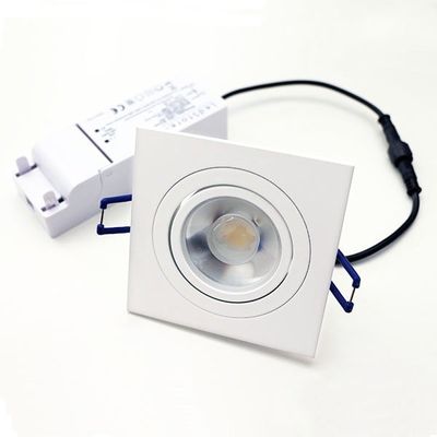 Square LED ceiling luminaire with exposed bulb, white housing, blue holders and power supply with white background for energy efficient lighting solutions.