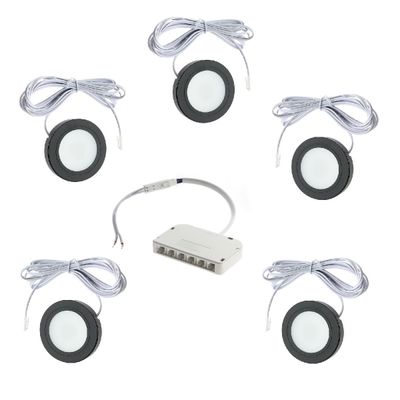 Six round LED disc lights with wires arranged in a circular pattern around a white control box for modern and efficient lighting solutions.