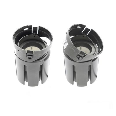 Alternative text: 'Two cylindrical LED luminaires with open tops and vertical grooves on a white background in a luminaire movement.