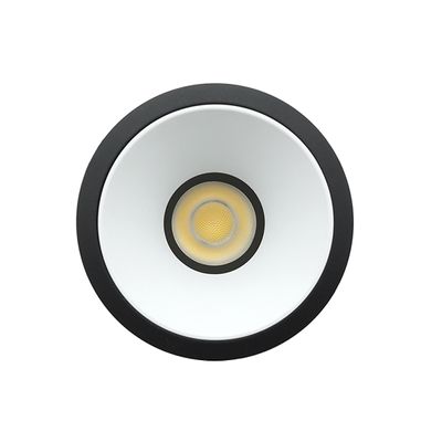 Round LED luminaire with black rim, white cone and bulb - ideal energy efficient lighting for modern spaces.