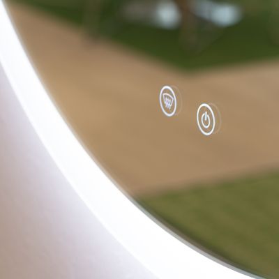 Backlit mirror with touchscreens for fan and power, enhancing the modern design; an ideal environmental example of LED lighting movement.